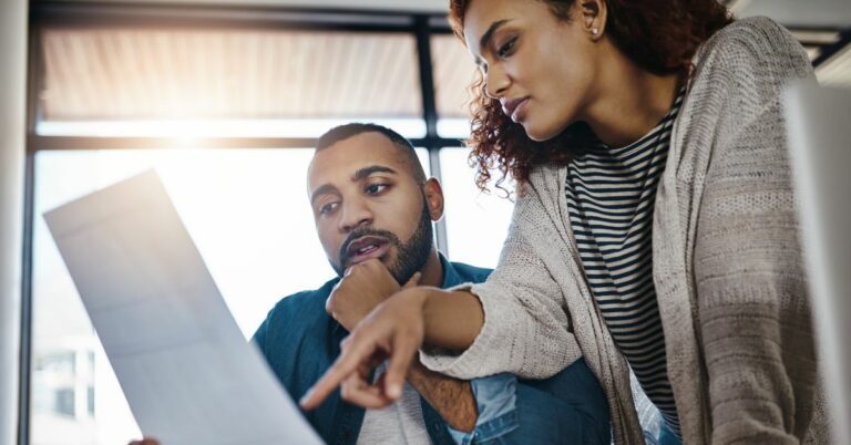 A young Couple Planning Their Budget at Home