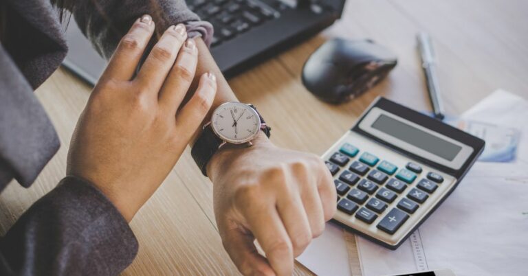 businesswoman checking the time on watch