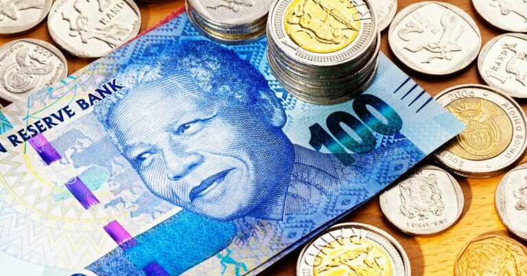 South African One Hundred Rand banknote and coins